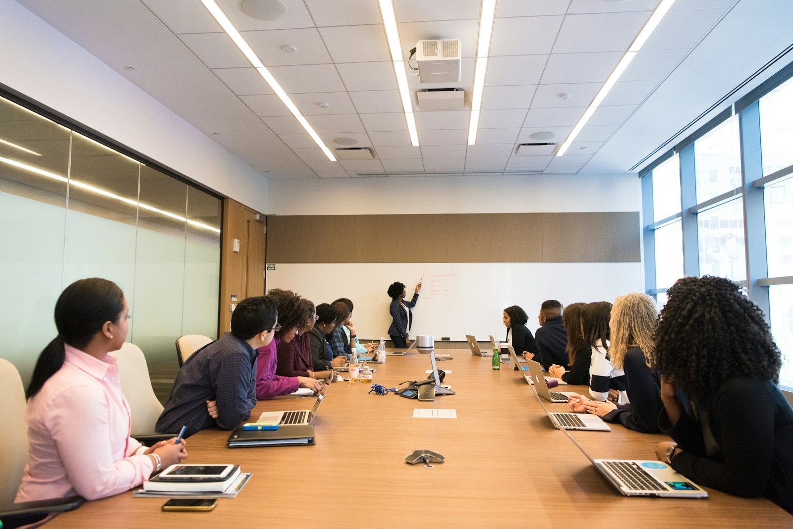 Team listening to a colleague presenting in a meeting room