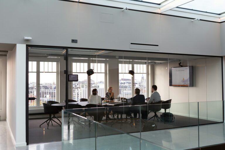 Executives seated around a boardroom table in discussion
