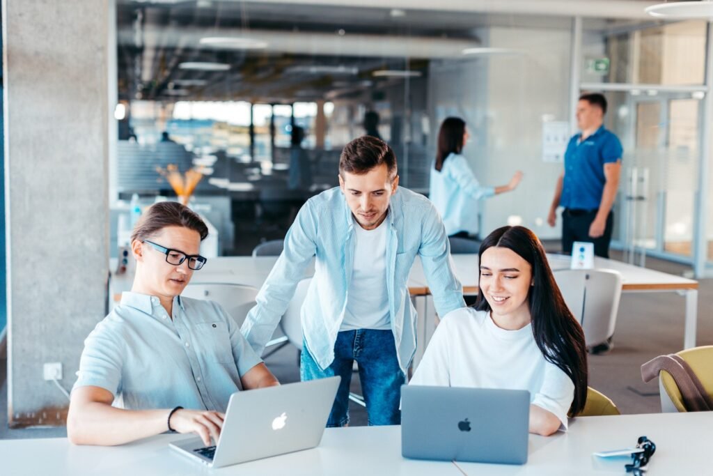 Small team working together around laptops
